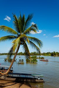 Wooden boats on the Mekong River, located on Don Det Island which forms part of the Four Thousand Islands, known locally as Si Phan Don.