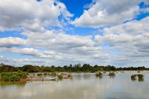 Wooden boats on the Mekong River, located on Don Det Island which forms part of the Four Thousand Islands, known locally as Si Phan Don.