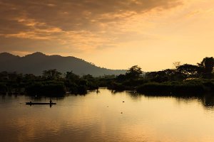 Fishermen on the Mekong River at sunset, located on Don Det Island which forms part of the Four Thousand Islands, known locally as Si Phan Don.