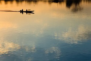 Fishermen on the Mekong River at sunset, located on Don Det Island which forms part of the Four Thousand Islands, known locally as Si Phan Don.