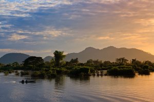 Fishermen on the Mekong River at sunset, located on Don Det Island which forms part of the Four Thousand Islands, known locally as Si Phan Don.