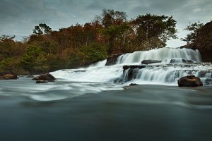 The serene Tad Lo waterfall surrounded by lush vegetation, located in the Bolaven Plateau which was named after the Laven ethnic group which has historically dominated the region.