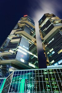 The illuminated Lippo Centre, a pair of twin office towers in Hong Kong, previously known as the Bond Centre, located at 89 Queensway in the Admiralty District on Hong Kong Island.