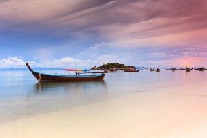 A long-tail boat at sunset on Ko Lipe, a small island surrounded by the Andaman Sea and located near the Tarutao National Park in southwest Thailand.