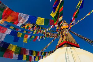 An ancient stupa surrounded by colourful prayer flags at the UNESCO World Heritage Site of Bodhnath, also called Boudha or Bouddhanath, one of the holiest Buddhist sites in Kathmandu.