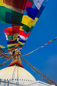 An ancient stupa surrounded by colourful prayer flags at the UNESCO World Heritage Site of Bodhnath, also called Boudha or Bouddhanath, one of the holiest Buddhist sites in Kathmandu.