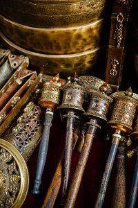 Prayer wheels with Om Mani Padme Hum inscription, a Tibetan Buddhist prayer, for sale in Thamel, a popular tourist destination in Kathmandu, Nepal.