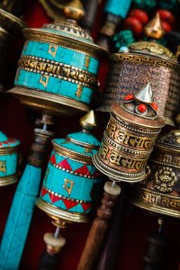 Prayer wheels with Om Mani Padme Hum inscription, a Tibetan Buddhist prayer, for sale in Thamel, a popular tourist destination in Kathmandu, Nepal.