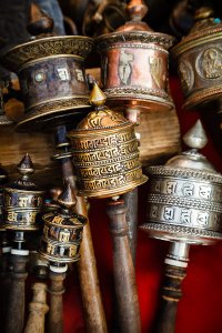 Prayer wheels with Om Mani Padme Hum inscription, a Tibetan Buddhist prayer, for sale in Thamel, a popular tourist destination in Kathmandu, Nepal.
