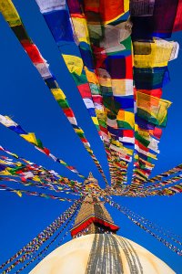 An ancient stupa surrounded by colourful prayer flags at the UNESCO World Heritage Site of Bodhnath, also called Boudha or Bouddhanath, one of the holiest Buddhist sites in Kathmandu.