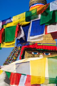 An ancient stupa surrounded by colourful prayer flags at the UNESCO World Heritage Site of Bodhnath, also called Boudha or Bouddhanath, one of the holiest Buddhist sites in Kathmandu.