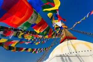 An ancient stupa surrounded by colourful prayer flags at the UNESCO World Heritage Site of Bodhnath, also called Boudha or Bouddhanath, one of the holiest Buddhist sites in Kathmandu.