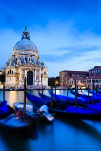 View of the Grand Canal and gondola boats, with the Basilica di Santa Maria della Salute in the background, located in the UNESCO World Heritage Site of Venice.
